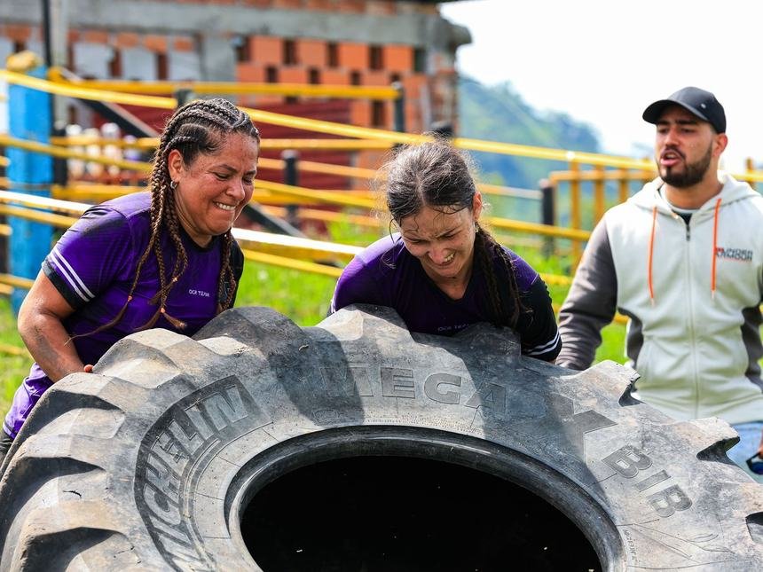 Athletes flipping a heavy tractor tyre outdoors