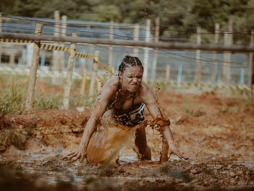 Competitor crawling through deep mud